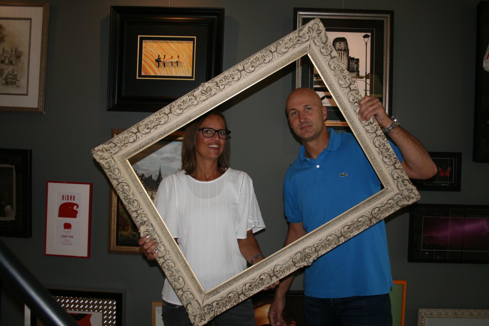 Bas en Jacqueline in hun atelier, samen achter een klassieke ornamentlijst